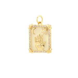 Macro shot of 18k gold plated Hamsa hand and Evil Eye pendant with cubic zirconia