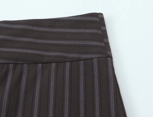 Close-up of brown pinstripe woven fabric showing high-quality stitching and texture
