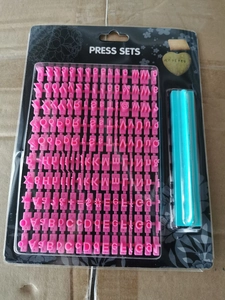 Detailed view of pink plastic letter and number stamp set for DIY baking on card