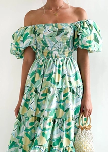 Detail of puff sleeves and elasticated bodice on green tropical leaf print dress