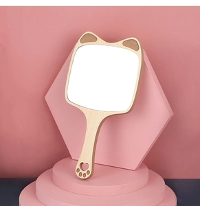 Handheld wooden makeup mirror with cute cat ears design and heart paw cutout on pink base
