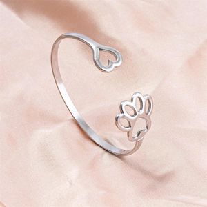 Minimalist stainless steel open bangle featuring heart and paw print hollow patterns