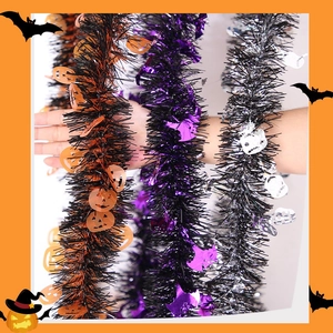 Detail of Halloween tinsel garland with orange pumpkin and purple ghost sequins