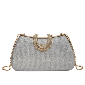 Sparkling silver clutch bag with rhinestone horseshoe handle and gold chain strap