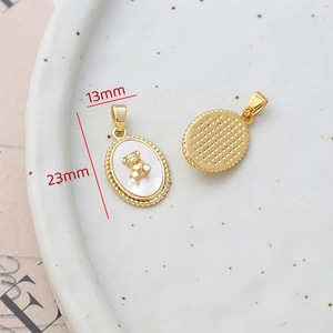Macro view of 14k gold-filled bear pendant with natural mother of pearl shell detail
