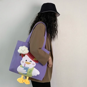 Purple canvas tote bag with cartoon white duck print and cloud plush keychain accessory