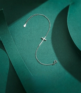Macro detail of S925 sterling silver cross bracelet with adjustable extension chain