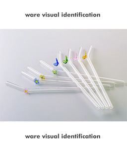 Detail of bent heat-resistant glass straws with colorful glass butterfly and flower crafts