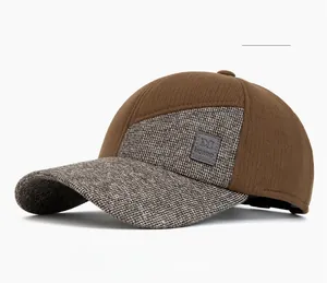 Detail of winter baseball cap with leather logo patch and mixed grey khaki fabric