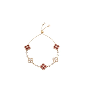 18k gold plated four-leaf clover bracelet with red enamel and pavé crystals on white background