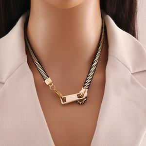 Creative gold zipper necklace with black fabric strap on a professional fashion model