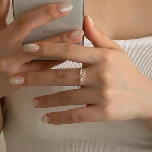 Detail of S925 sterling silver open ring with hollow heart and zircon on hand