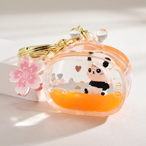 Macro detail of orange liquid panda charm in acrylic TV-shaped container keychain
