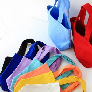 Colorful canvas lunch tote bags in various vibrant colors displayed on a white background