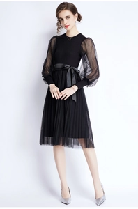 Detail of knit midi dress with sheer polka dot sleeves and pleated mesh skirt finish
