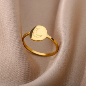 Detailed view of 18K gold stainless steel moon ring on elegant silk background