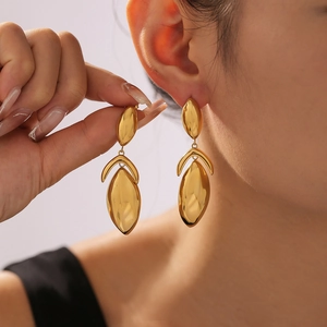 Gold geometric drop earrings with triple oval links in a minimalist chic style