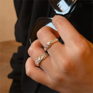 Detail of s925 silver lava rings with pink heart gemstone and irregular texture