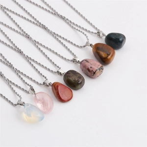 Detailed view of irregular natural stone crystal pendants with metallic cord chains