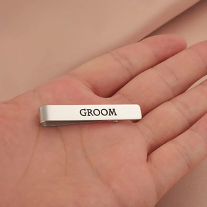 Polished silver tie clip featuring engraved black GROOM lettering for wedding suits