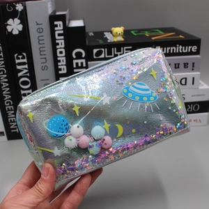 Detailed macro of holographic silver travel bag with planet prints and shiny sequins