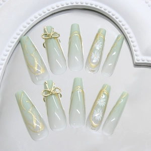 Green daisy press-on nails with golden irregular lines and 3D bow on long trapezoid shape