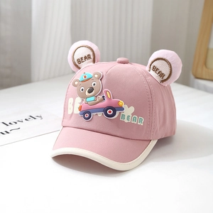 Detail of pink cotton baby hat featuring 3D plush bear ears with embroidery and a cartoon car