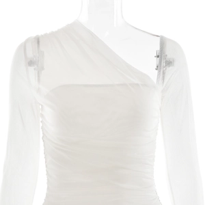 Detailed view of white mesh sleeve and ruffled ruched fabric on asymmetrical dress