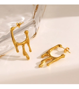 Detailed shot of gold liquid lava drop earrings in polished stainless steel finish