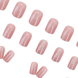 Pink cat eye press-on nails with silver glitter lines and minimalist metallic accents