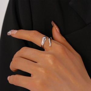 Close-up of a silver minimalist snake-shaped open ring with a polished mirror finish