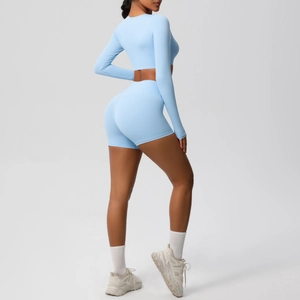 Detail of light blue brushed fabric yoga set featuring long sleeve crop top and shorts