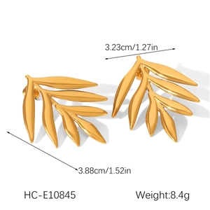Detail view of 18K gold leaf earrings showing 3.88cm size and polished metal texture
