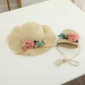 Girls straw sun hat and matching bag set with floral accents and wavy brim for summer