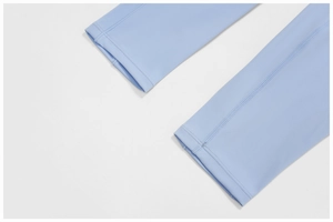 Close-up of light blue yoga leggings hem showing high-quality double-needle stitching