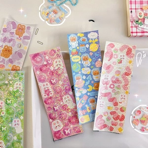 Close-up of colorful laser stickers with cartoon bears and rabbits for DIY journals