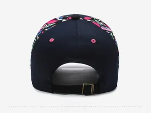 Detail view of navy blue baseball cap with graffiti print and metal adjustable buckle