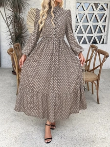 Outdoor shot of an elegant long-sleeve dress with geometric prints and buttoned high neck