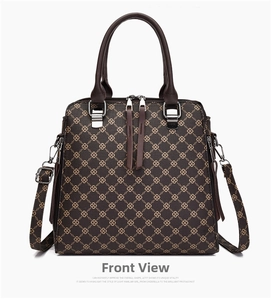 Detailed shot of dark brown tote bag featuring printed chain texture and silver hardware