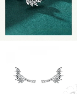 Macro detail of 925 sterling silver wing earrings set with marquise-cut cubic zirconia