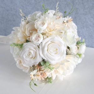 Elegant white rose and dahlia bridal bouquet for weddings with lush green leaves