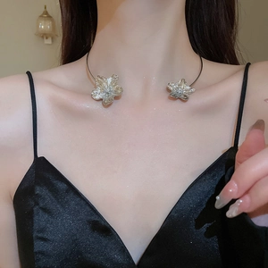 Detailed view of silver metallic floral choker with textured petals on female model