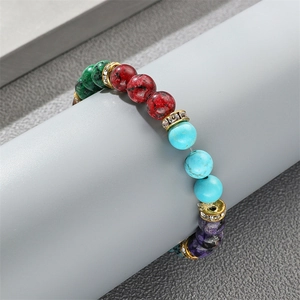 Colorful agate beaded bracelet with gold rhinestone spacers on a display stand