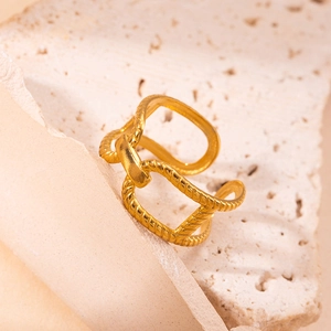 Detailed view of golden open ring featuring double twist texture and metallic buckle