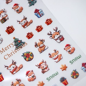 3D Christmas nail stickers with embossed reindeer, foxes and festive trees on white backdrop