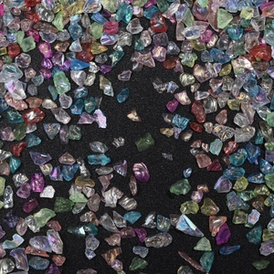 Macro shot of irregular colorful glass fragments for DIY nail art and craft decoration