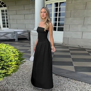 Detail of a chic black tube top maxi dress with backless design in an outdoor setting