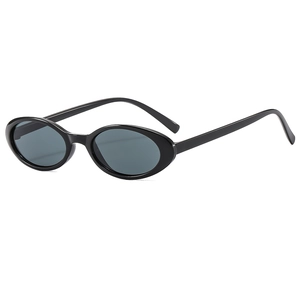 Vintage narrow oval sunglasses with black frames and grey lenses for a retro look