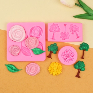 Pink silicone fondant molds featuring rose, leaf, and tree shapes for DIY cake decorating