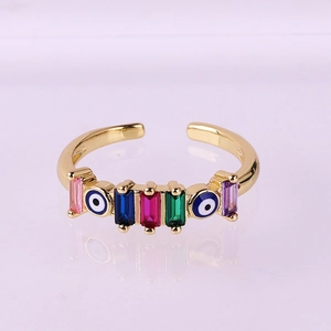 Detailed macro view of gold-plated evil eye ring with multi-color zircon stones